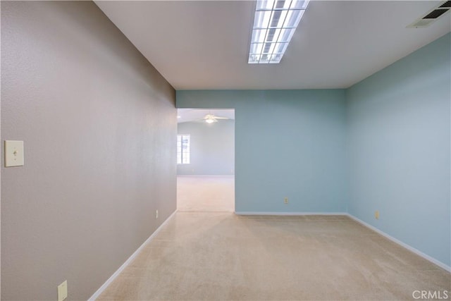 unfurnished room featuring visible vents, carpet flooring, a ceiling fan, and baseboards