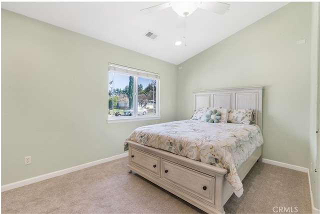 bedroom with light carpet, baseboards, and lofted ceiling