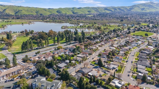 drone / aerial view featuring a residential view and a water and mountain view