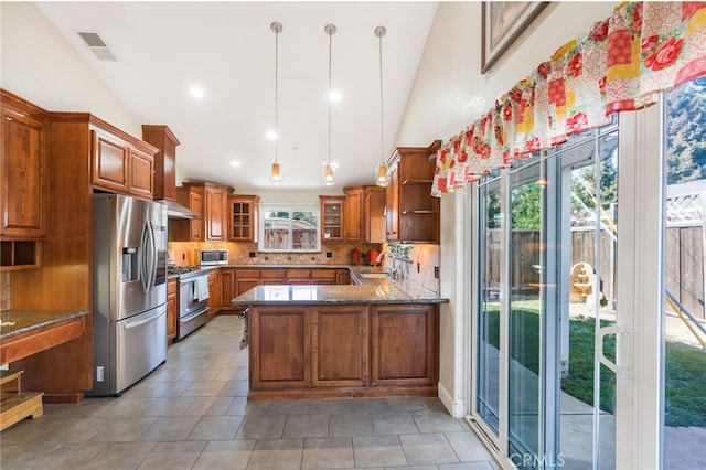 kitchen with visible vents, lofted ceiling, brown cabinetry, stainless steel appliances, and a sink