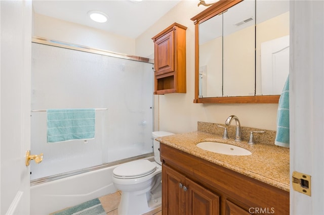 bathroom featuring tile patterned flooring, visible vents, bath / shower combo with glass door, toilet, and vanity