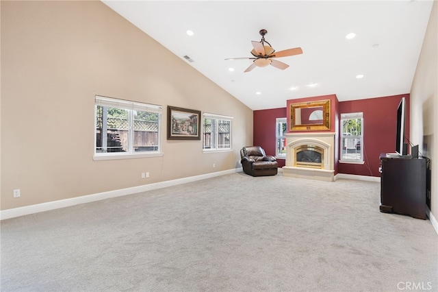 unfurnished room with visible vents, ceiling fan, carpet, a glass covered fireplace, and high vaulted ceiling