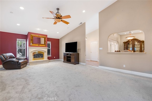 unfurnished living room featuring a ceiling fan, baseboards, recessed lighting, a glass covered fireplace, and carpet flooring