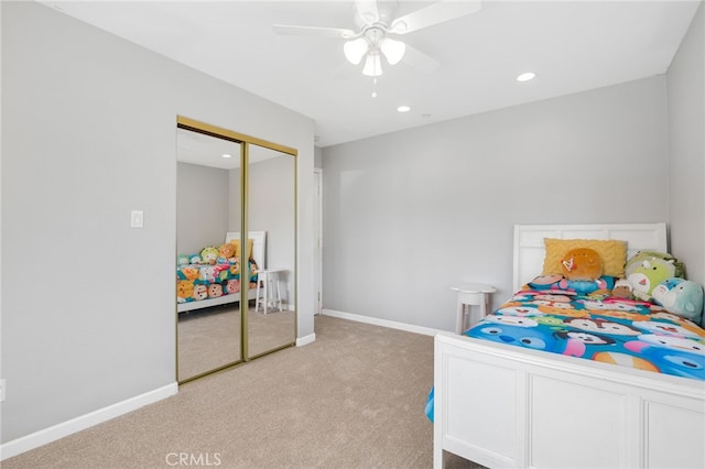 bedroom with recessed lighting, a closet, baseboards, and light colored carpet