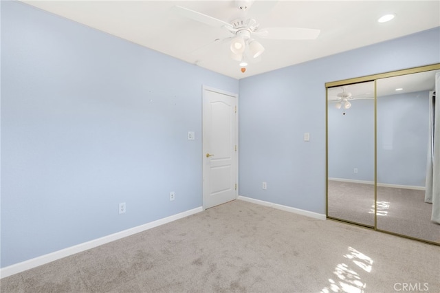 unfurnished bedroom featuring a closet, baseboards, carpet floors, and a ceiling fan