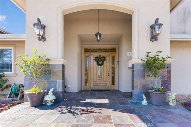 view of exterior entry with stucco siding