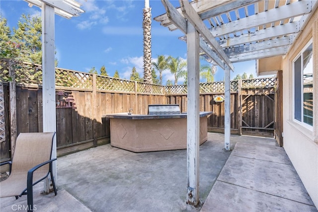 view of patio / terrace featuring exterior kitchen, fence, and a pergola