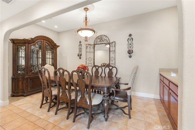 dining room with light tile patterned floors, recessed lighting, and baseboards