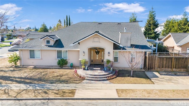 view of front of property with stucco siding and fence