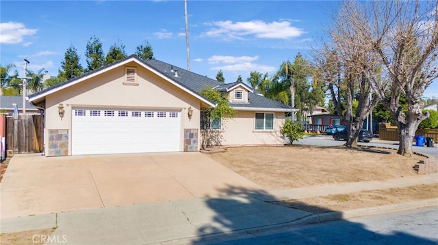 single story home featuring fence, stucco siding, concrete driveway, a garage, and stone siding