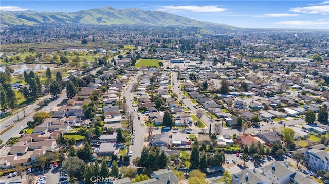 drone / aerial view featuring a residential view and a mountain view