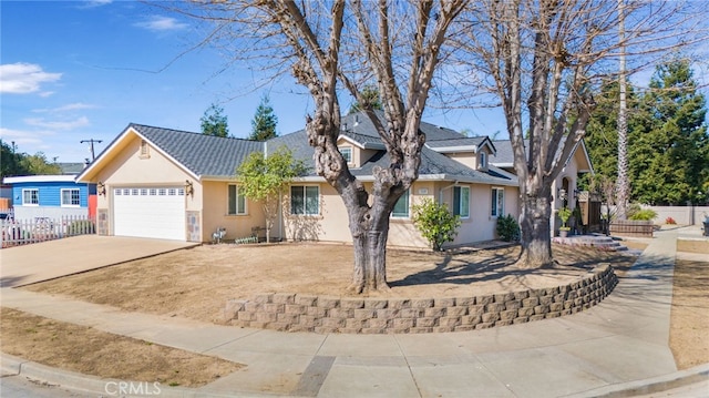 view of front facade featuring fence, a tiled roof, stucco siding, a garage, and driveway