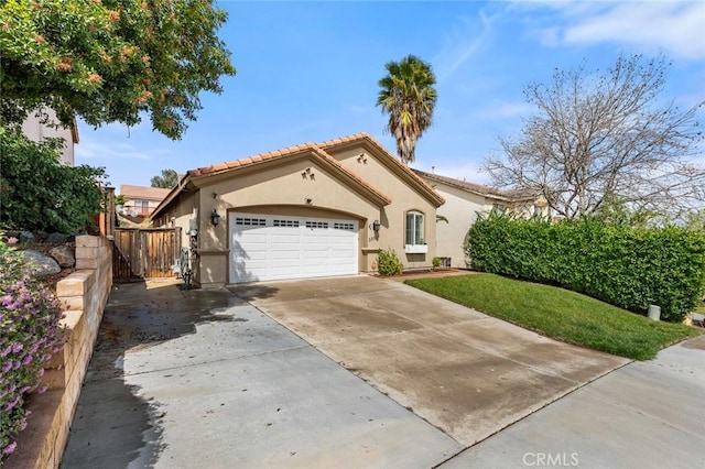 mediterranean / spanish-style home with concrete driveway, a tiled roof, an attached garage, and stucco siding