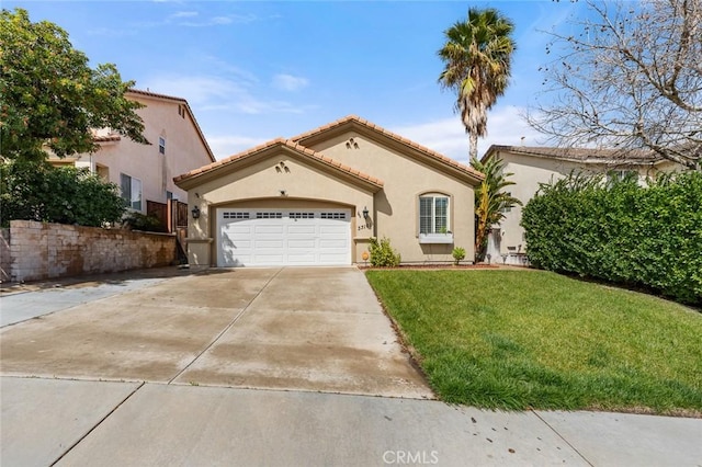 mediterranean / spanish-style home with a tile roof, concrete driveway, a front yard, stucco siding, and an attached garage