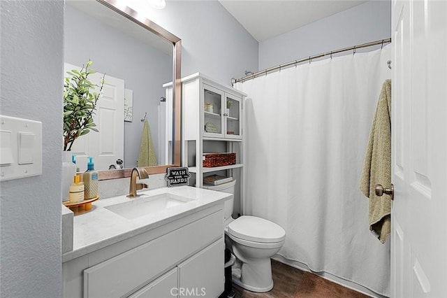 full bath with a shower with shower curtain, toilet, wood finished floors, and vanity