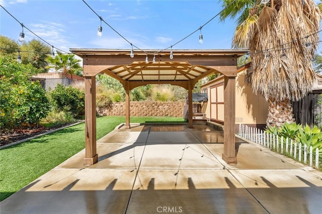 view of patio with an outbuilding and a fenced backyard