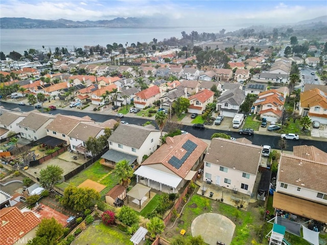 birds eye view of property with a residential view and a water view