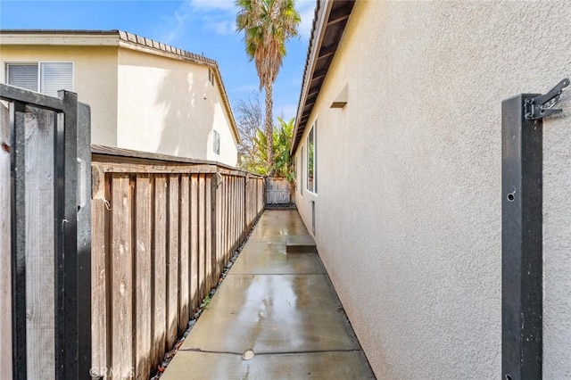 view of home's exterior with fence and stucco siding