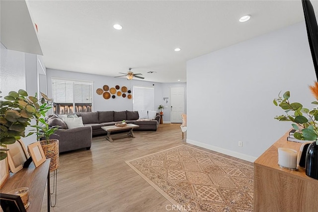 living area with recessed lighting, baseboards, light wood-type flooring, and ceiling fan