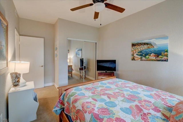 bedroom featuring a ceiling fan, carpet, a closet, and baseboards