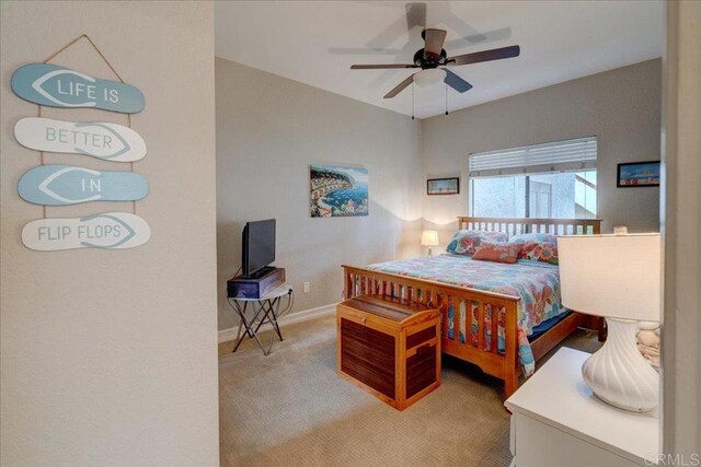 bedroom featuring ceiling fan, baseboards, and light carpet