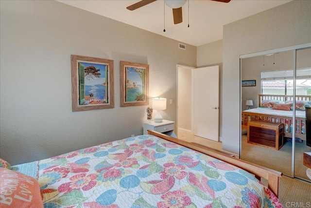 bedroom featuring a closet, visible vents, carpet flooring, and ceiling fan