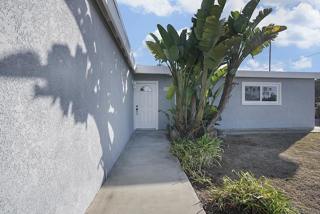 view of exterior entry with stucco siding