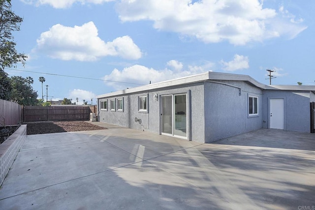 back of house with a patio area, stucco siding, and a fenced backyard