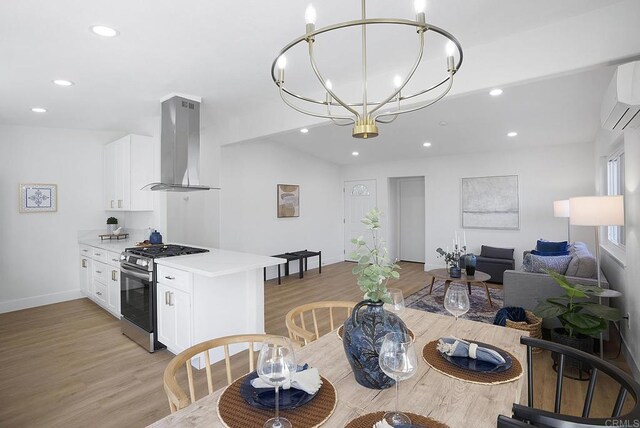 dining room featuring recessed lighting, baseboards, light wood-style floors, and a wall mounted air conditioner