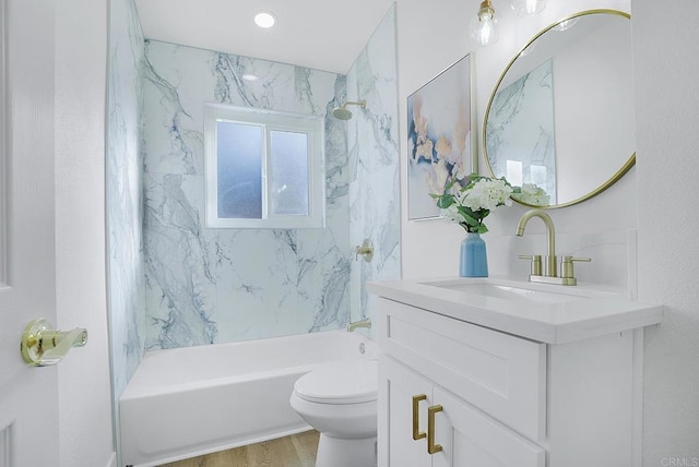 bathroom featuring vanity, wood finished floors, toilet, and tub / shower combination