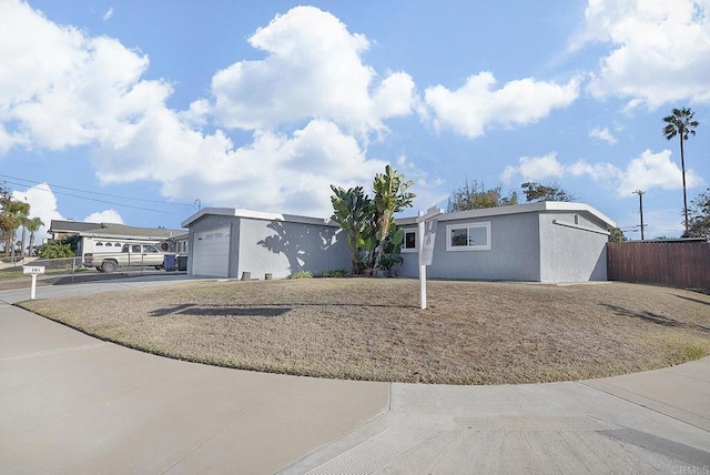 ranch-style house featuring a garage, fence, concrete driveway, and stucco siding