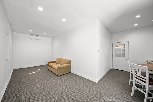 sitting room featuring an AC wall unit, recessed lighting, carpet, and baseboards