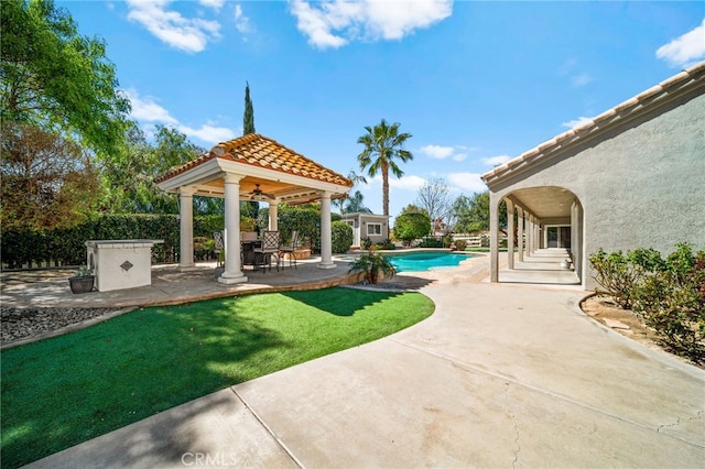 view of patio featuring a gazebo and a fenced in pool