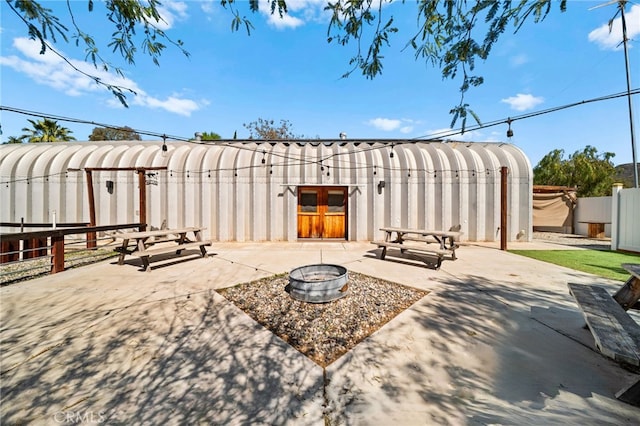 view of patio with a fire pit and fence