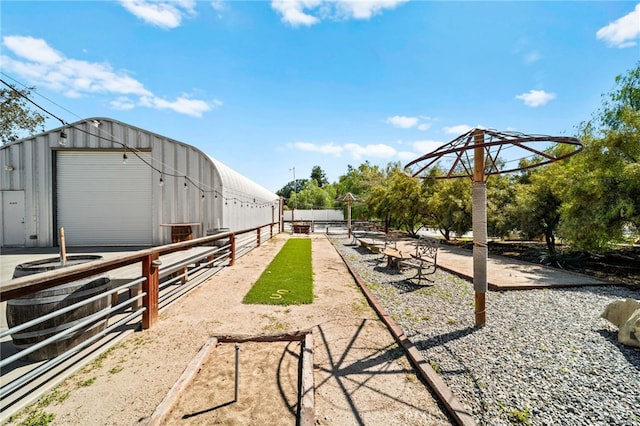 exterior space featuring an outbuilding and fence