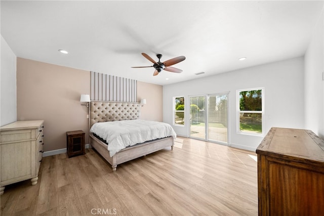 bedroom featuring visible vents, light wood-style flooring, baseboards, and access to outside