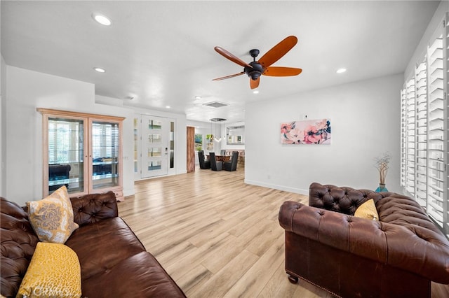 living room featuring baseboards, visible vents, recessed lighting, ceiling fan, and light wood-style floors