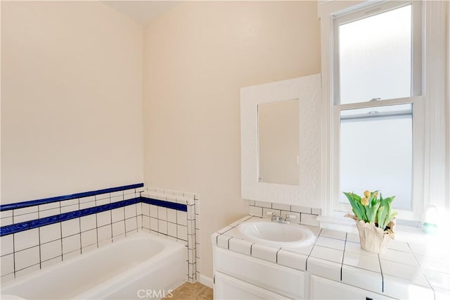 full bath with a garden tub and vanity