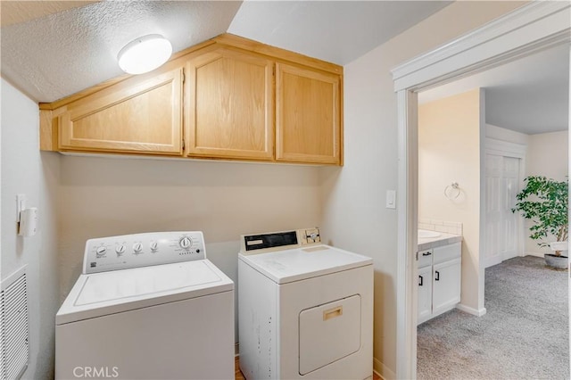 laundry area with washer and dryer, baseboards, cabinet space, and light colored carpet