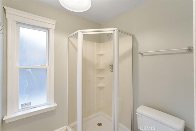 full bathroom with a shower stall and toilet