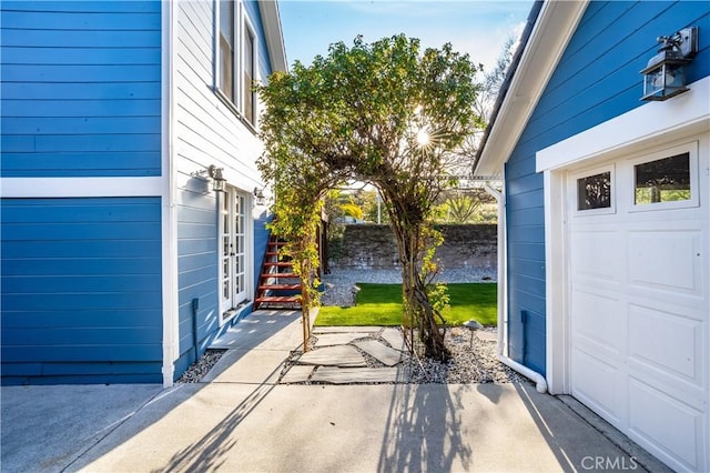 view of patio / terrace with a garage and fence