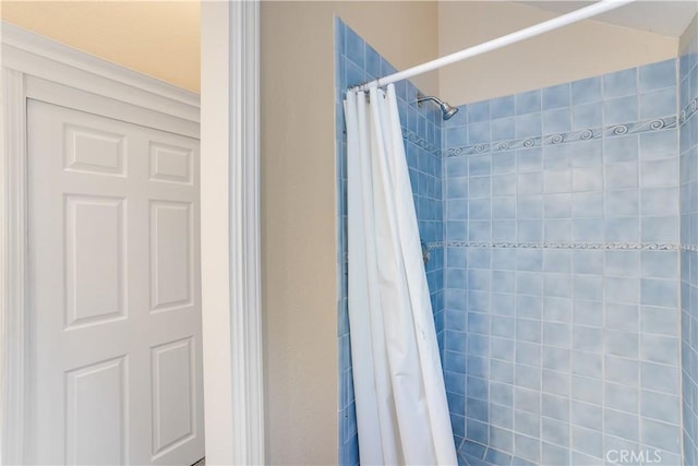 full bathroom with a tile shower