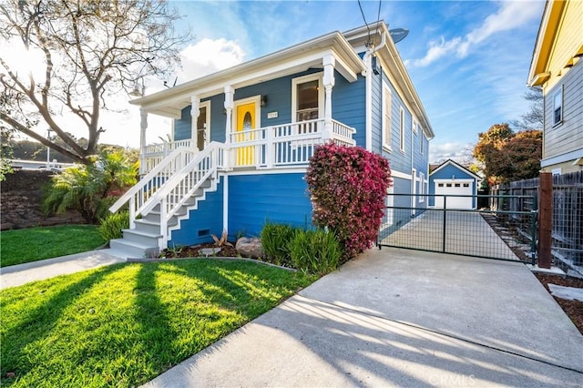 bungalow with fence, covered porch, an outdoor structure, concrete driveway, and a detached garage