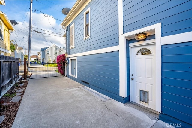 garage with a gate, a residential view, and fence