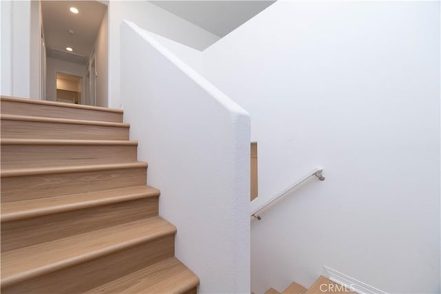 stairway featuring recessed lighting