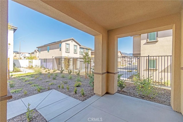 view of yard with a patio, a fenced backyard, and a residential view