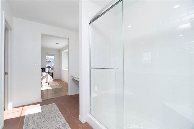 full bathroom featuring ensuite bath, tile patterned floors, and a stall shower