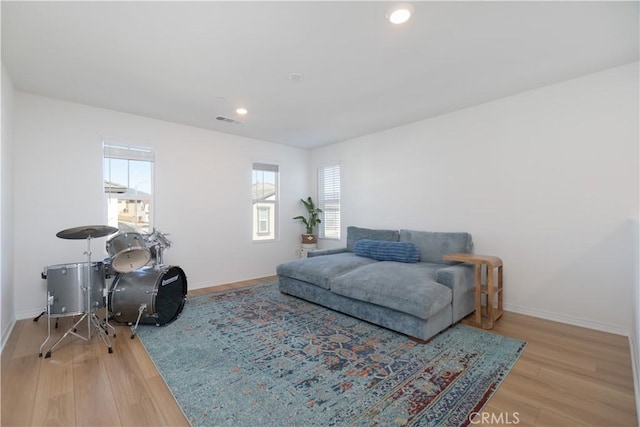 interior space featuring recessed lighting, wood finished floors, visible vents, and baseboards