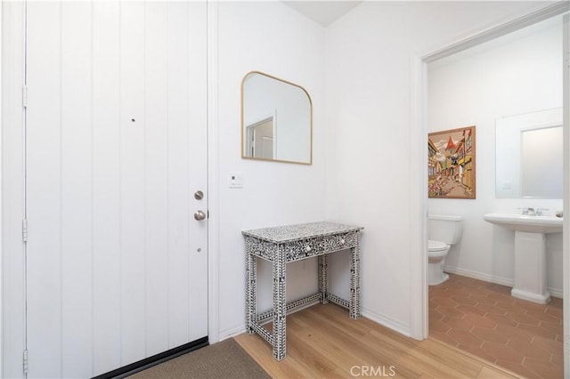 interior space with baseboards and light wood-style floors