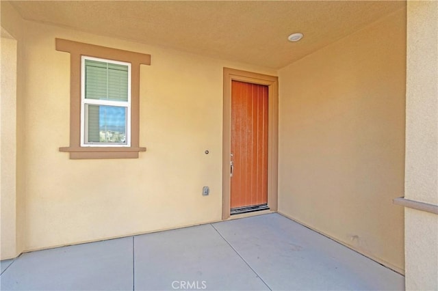 entrance to property with stucco siding